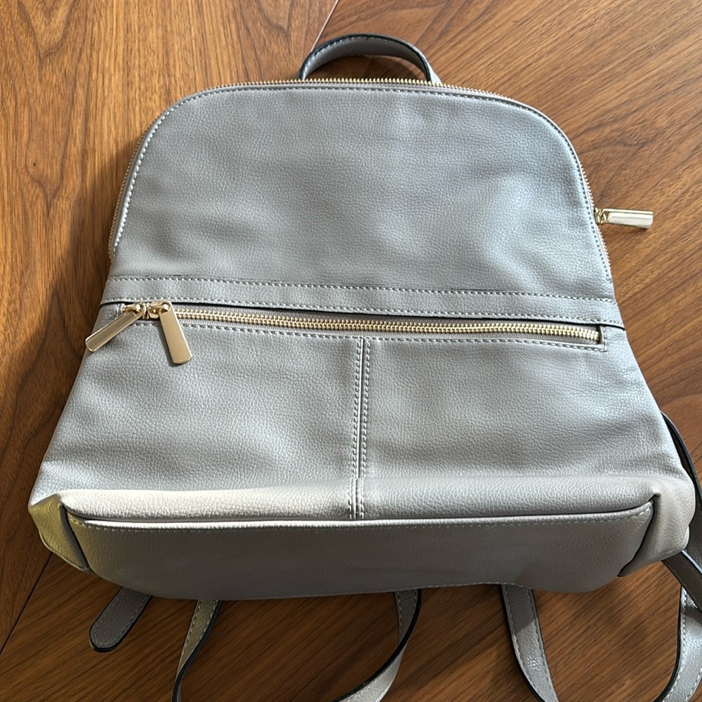 A New Day gray backpack purse. Gold accents. 13”. Gently used.